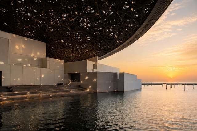 Louvre Abu Dhabi dome and water at dusk